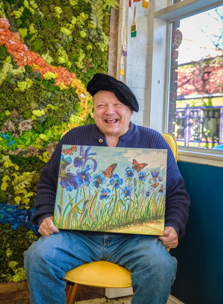 Senior man showing off the painting he made and smiling | Art Therapy | Merely Creative Martinsburg WV