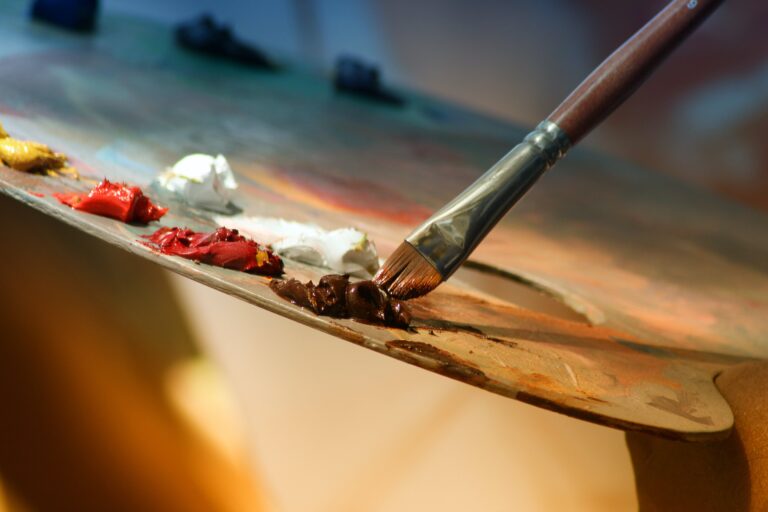 Paint brush dipped in paint on an easel | Art Therapy | Merely Creative, Martinsburg WV